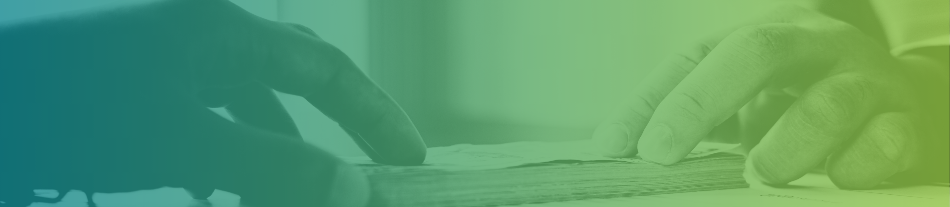 Close-up of two hands sorting through a stack of papers, conveying a sense of focus and organization.