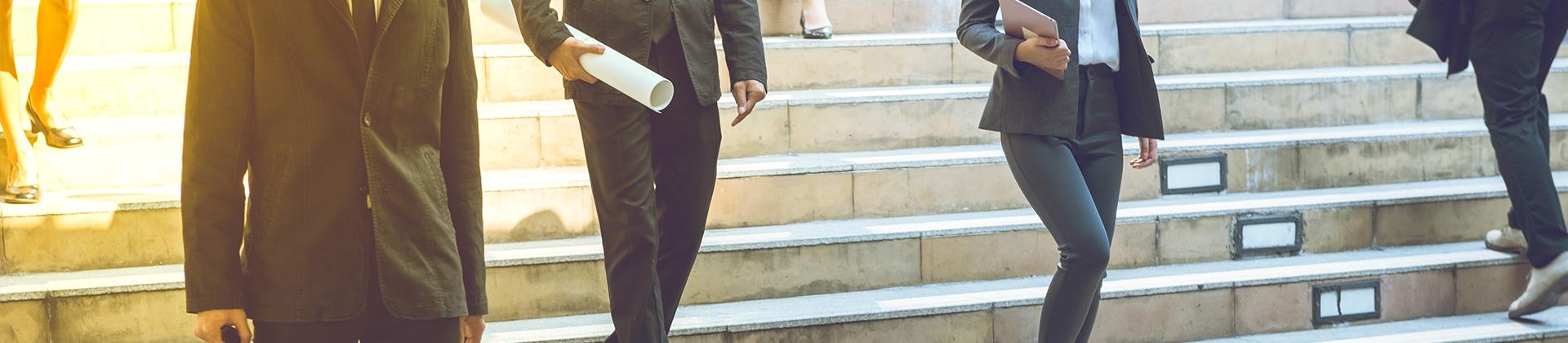 Business people walking down stairs 