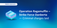 Media statement graphic with stacked documents and the headline “Operation Ragamuffin – Strike Force Danberta — Criminal charges laid,” in blue.